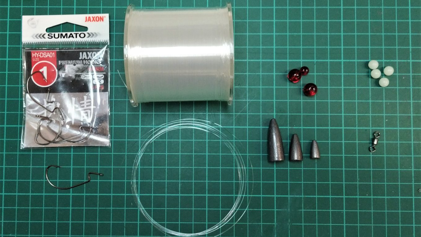 Benötigte Materialien zum Binden des Carolina Rigs - Offset Haken, Fluorocarbon Vorfachmaterial, Bulletweight, Glasperlen, Wirbel